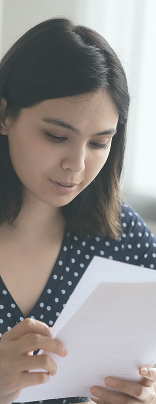 young woman reading a paper