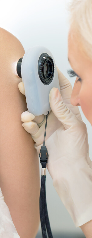 skin doctor performing skin cancer screening on patient