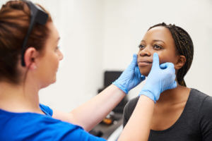 Doctor examining a face